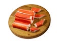 Crab sticks on wooden cutting board isolated on white background Royalty Free Stock Photo