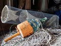 Crab Trap and Fishing Float Resting on Nets Royalty Free Stock Photo