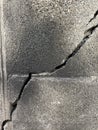 Crack background of old gray brick wall which is a relatively large crack