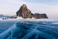 Crack freezing water lake with rocky island, winter season Baikal Russia