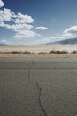 Crack in road with desert background Royalty Free Stock Photo