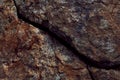 Crack in the rock on mountain in brown colors.