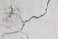 Crack. Texture of old painted white plaster. Cracked wall. Royalty Free Stock Photo