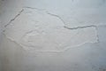 Crack. Texture of old painted white plaster. Cracked wall. white wall with cracks Royalty Free Stock Photo