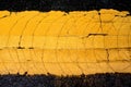 Crack yellow line painted on asphalt road