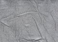 Cracked leather close-up fabric wrinkled gray background