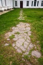 Cracked asphalt path to the doors of the old palace. The palace and park complex Manor Tarnowski, s.Kachanovka, Ukraine.