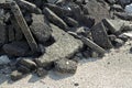 Cracked asphalt pieces after demolition of a road surface in a construction site for renovation ready to be recycled