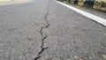 Cracked asphalt road surface background. Surface texture of old asphalt road with cracks. Royalty Free Stock Photo