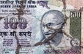 On the cracked asphalt there is an image of a banknote of India