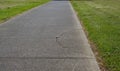 Cracked asphalt on walking path