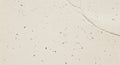 Cracked Beige Surface Texture with Dark Flecks, Natural Stone Background Royalty Free Stock Photo