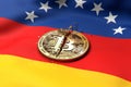 Cracked Bitcoin coin on Venezuelan flag. Bad Bitcoin condition in Venezuela concept. 3D Rendering