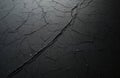 Cracked black plastic surface shows knife marks and deep scratches. Texture reveals rough aging and wear. Dark, abstract pattern Royalty Free Stock Photo