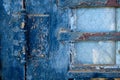 Cracked blue paint and reinforced widow on weathered old door Royalty Free Stock Photo