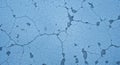 Cracked blue surface with an irregular pattern resembling dried, parched earth. The texture Royalty Free Stock Photo