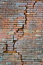 Cracked brick wall. Deep crack in a brick wall