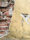 Cracked and broken stucco over a red brick wall Royalty Free Stock Photo