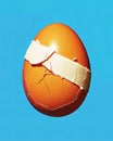 Cracked Chicken egg patched with band aid. Generative Ai Royalty Free Stock Photo