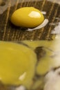 cracked chicken egg spreads on a black wooden board, side view Royalty Free Stock Photo