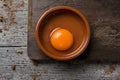 Cracked chicken egg on a wooden table