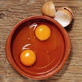 Cracked chicken eggs on a wooden table Royalty Free Stock Photo