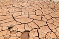 Cracked clay soil in front of the Flaming Mountains in China, Xinjiang province. Located in the Turpan depression