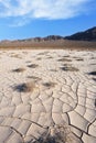 Cracked clay - takyr - surrounds a huge dune