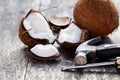 Cracked coconuts and hammer on old wooden table Royalty Free Stock Photo