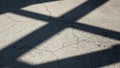 Cracked concrete surface with shadows forming geometric patterns Royalty Free Stock Photo
