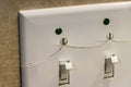 Cracked and damaged light switch wall plate Royalty Free Stock Photo