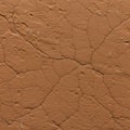 Cracked, dried mud texture with a reddish-brown color, displaying an intricate pattern Royalty Free Stock Photo
