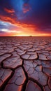 Cracked Earth and Color Ripples: A Stunning Sunset in the Desert Royalty Free Stock Photo