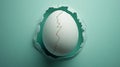 Cracked egg breaking through a teal background. Royalty Free Stock Photo
