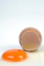 Cracked egg, eggshell with yolk isolated on white background Royalty Free Stock Photo