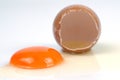 Cracked egg, eggshell with yolk isolated on white background Royalty Free Stock Photo