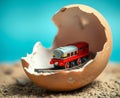 Cracked egg with a miniature train track and toy train inside Royalty Free Stock Photo