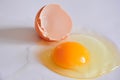 Cracked Egg with Yolk and Shell on White Background marco shot Royalty Free Stock Photo