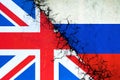 Cracked flags of Russia and England. International political relations. Conflict. Political Economic background. Royalty Free Stock Photo