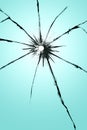 Cracked glass with a hole, broken window texture, bullet hole. Royalty Free Stock Photo