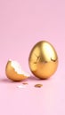 Cracked golden egg with broken shell on a soft pink background for Easter concept Royalty Free Stock Photo