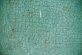 cracked green paint on an old metallic surface, rusted green painted metal wall, sheet of rusty metal with cracked and flaky paint Royalty Free Stock Photo