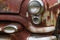 Cracked Headlight And Chipped Paint On Old Rusted Junkyard Car Royalty Free Stock Photo