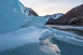 Cracked ice on a frozen lake captures sunset light Royalty Free Stock Photo