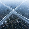 Cracked ice surface with trapped air bubbles visible beneath Royalty Free Stock Photo