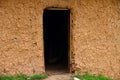 Cracked Mud House Wall with Dark Doorway Royalty Free Stock Photo