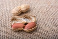 Cracked open peanuts with shell on a linen canvas Royalty Free Stock Photo