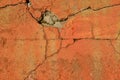 Cracked concrete wall painted in orange color Royalty Free Stock Photo