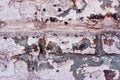 Cracked paint, plaster of soft gray-pink pastel color on brick wall surface close up detail, grunge horizontal background Royalty Free Stock Photo