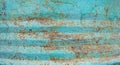 Cracked paint on rusty metal. Background texture cracked paint the color of sea foam and mint, visible rusty metal surface Royalty Free Stock Photo